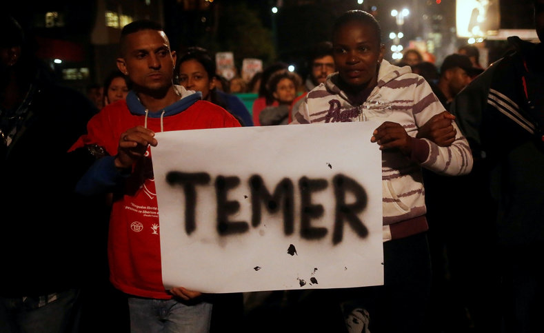 Members of Brazil's Homeless Workers' Movement (MTST) hold a banner with the name of Brazil's interim President Michel Temer during a protest against the impeachment of suspended Brazilian President Dilma Rousseff, at Paulista Avenue in Sao Paulo, Brazil, May 12, 2016. 