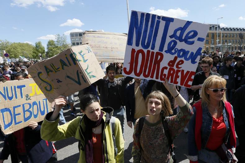 French labour union workers and students attend a demonstration against the French labour law proposal in Lyon, France, as part of a nationwide labor reform protests and strikes. The slogan reads 