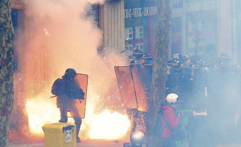 French riot police officers (CRS) face protestors during clashes during a demonstration against the French labour law proposal in Paris, France, as part of a nationwide labor reform protests and strikes, April 28, 2016.