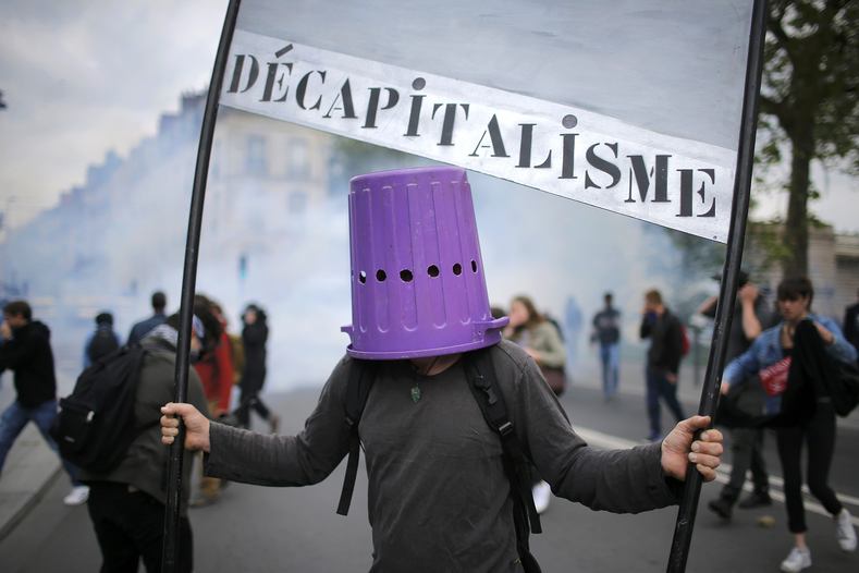 A protester wears a garbage can during a demonstration against French labour law reform in Nantes, France, May 17, 2016.