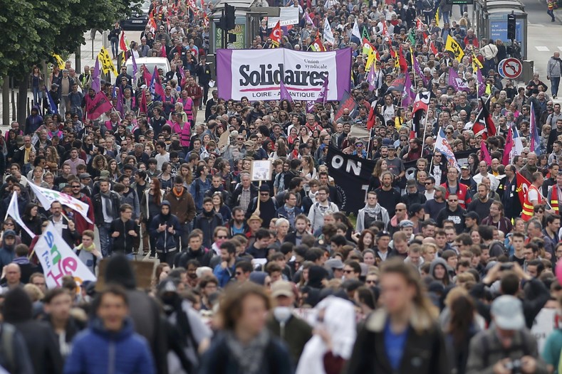 People march with labour union flags and banners at a demonstration to protest the proposed labour law reforms in Nantes, France, May 17, 2016. 