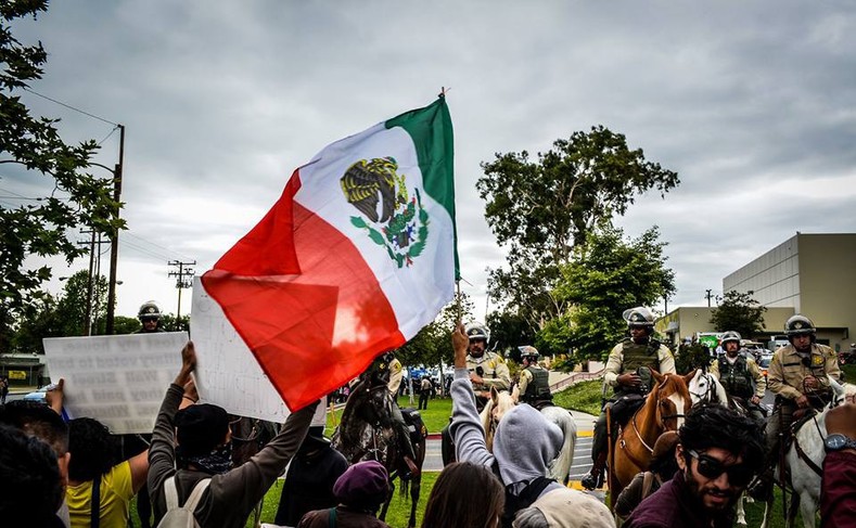 Protesters at East Los Angeles College hold up the Mexican flag, May 5, 2016.