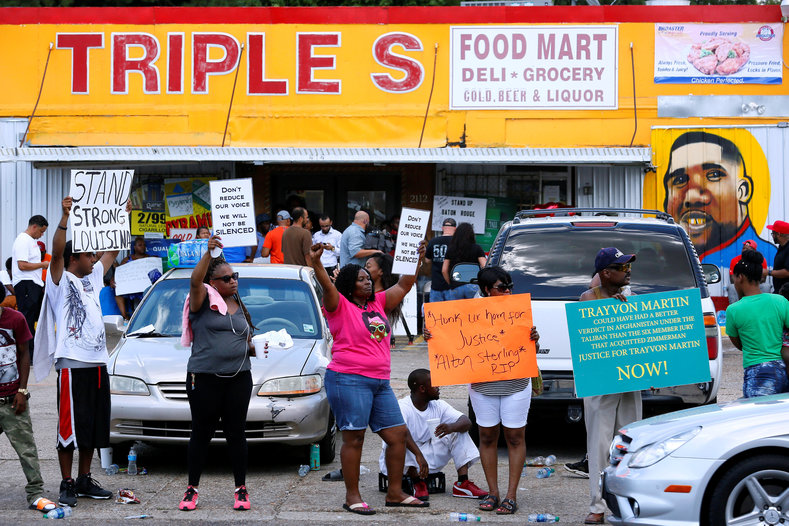 Protesters demonstrate outside the Triple S Food Mart where Alton Sterling was shot dead by police in Baton Rouge, Louisiana, U.S. July 7, 2016.