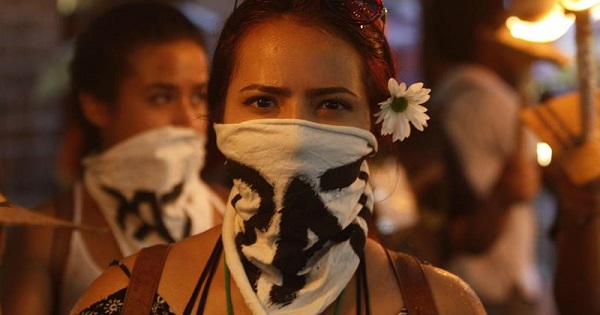 A demonstrator wearing a bandana with the word 