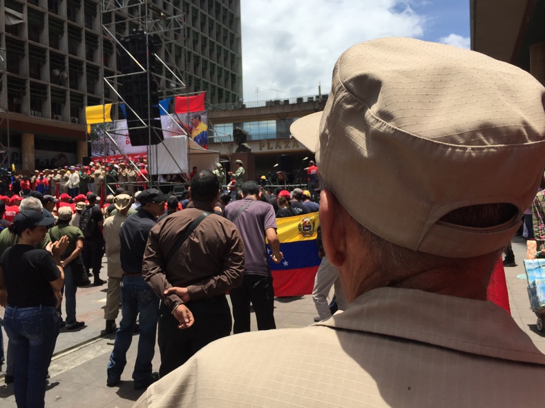 A member of the Venezuelan National Militia looks on as speakers rally government supporters in Caracas. 