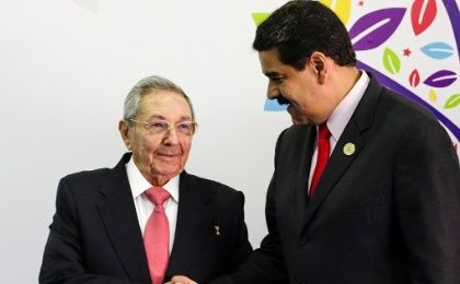 Venezuela's President Nicolas Maduro (R) welcomes Cuban President Raul Castro to the 17th Non-Aligned Summit