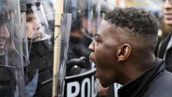 A demonstrator confronts police near Camden Yards during a protest against the death in police custody of Freddie Gray.