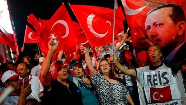 People shout slogans and wave Turkish national flags as they have gathered in solidarity night after night since the July 15 coup attempt in central Ankara, Turkey, July 27, 2016. 