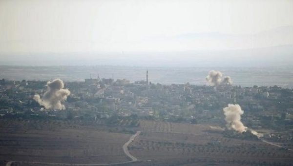 Smoke rises from explosions during fighting in the village of Jubata Al Khasab in Syria, as seen from the Israeli side of the border fence between Syria and the Israeli-occupied Syrian Golan. 