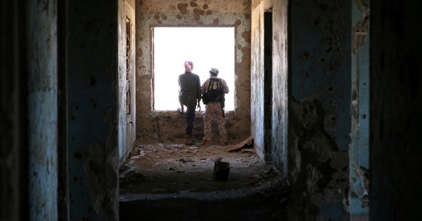 Rebel fighters stand in a damaged building in Quneitra countryside, Syria Sept. 10, 2016.
