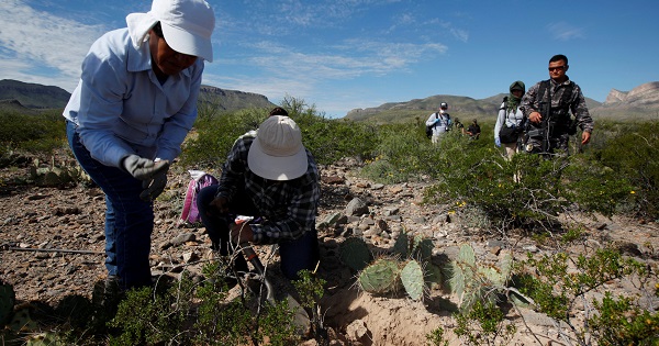 Human rights defenders, accompanied by police and forensic experts, search the Juarez Valley for remains of women who have gone missing, Sept. 16, 2016.