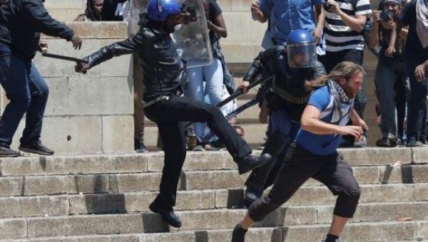  A riot police officer and private security guards attempt to detain a student at the Johannesburg's University of the Witwatersrand, South Africa.