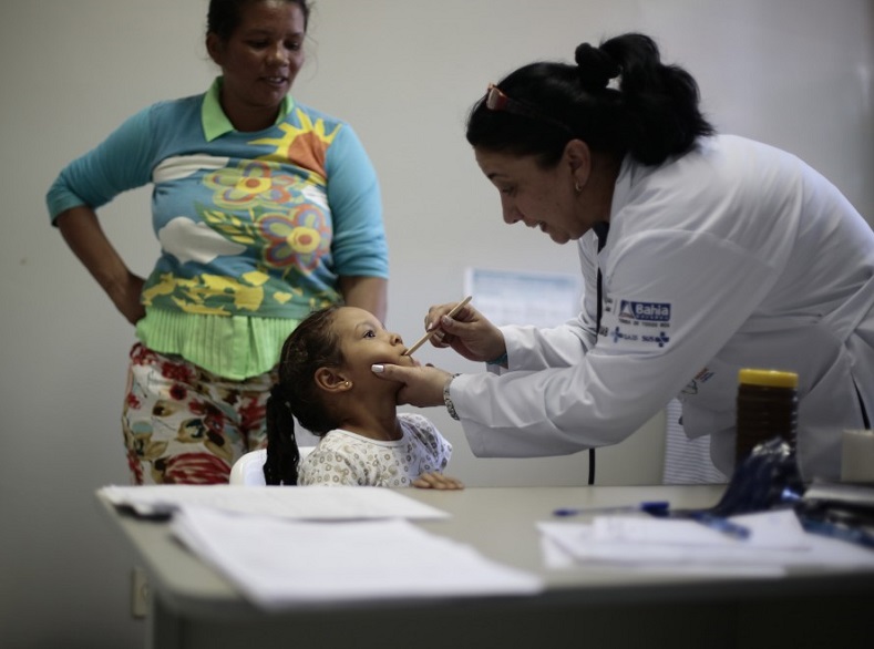 A Cuban doctor examines a young patient at the Health Center in the city of Jiquitaia in the state of Bahia, north-eastern Brazil, November 18, 2013.