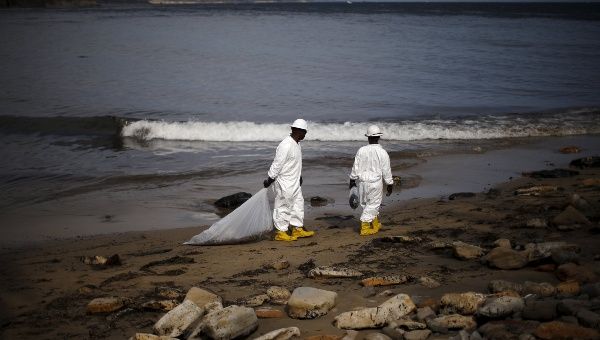 Workers clean up an oil slick along the coast of Refugio State Beach in Goleta, California, United States, May 21, 2015.