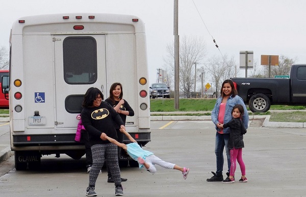 Women and girls play in a parking lot outside the Fort Peck Community College on the Fort Peck Indian Reservation in Montana, April 27, 2016.