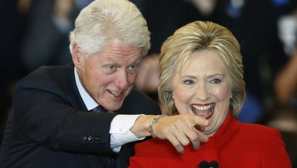 Democratic U.S. presidential candidate Hillary Clinton laughs with her husband, former President Bill Clinton.