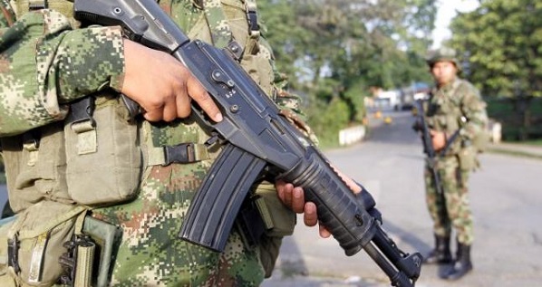 Colombian soldiers stand guard at a street in Caloto on Feb. 6, 2014.
