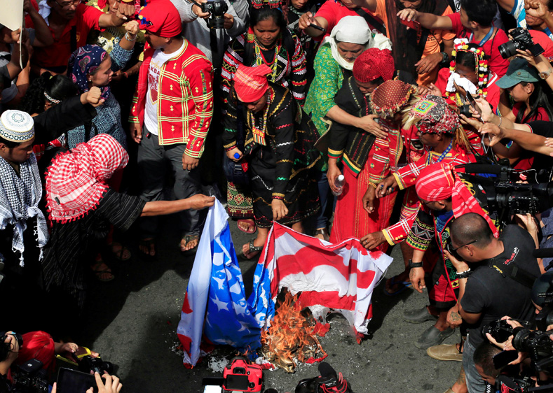 Various activists' and Indigenous people's groups burn a mock U.S. flag as they hold a rally supporting President Rodrigo Duterte's independent foreign policy in metro Manila, Philippines Oct. 21, 2016. 