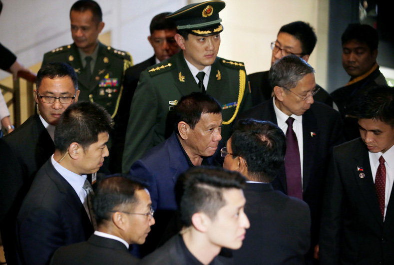 Philippines' President Rodrigo Duterte (C) leaves a hotel in Beijing, China, Oct. 21, 2016. 