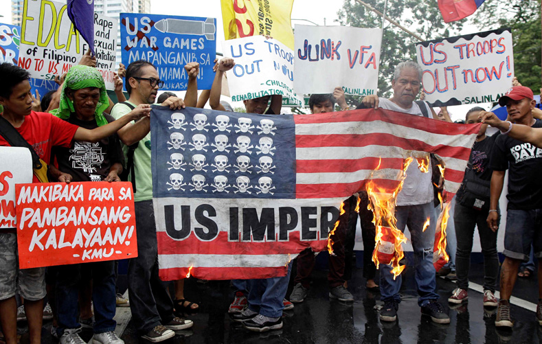 Indigenous communities have long resisted the U.S. role in militarizing their communities. Here, demonstrators burn a mock U.S. flag during a rally opposing the U.S.-Philippines joint military exercises outside the U.S. Embassy in Manila, Philippines on Oct. 4, 2016. 
