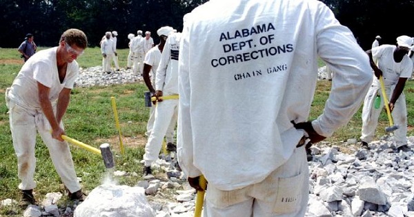 Alabama prison inmates crush limestone rocks with a sledgehammer outside the Limestone Correctional Facility