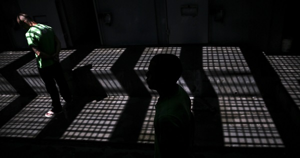 Two men walk through the halls of the Laercio da Costa Pellegrino maximum security jail in Rio de Janeiro, April 13, 2016.
