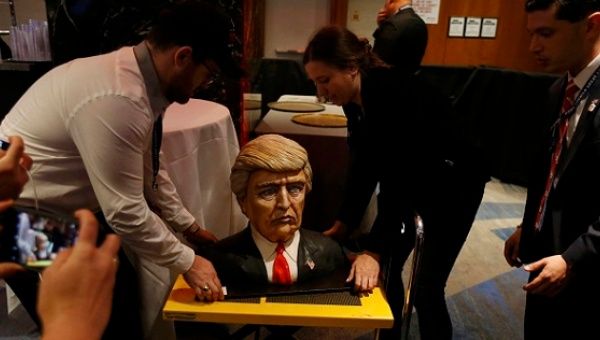 A cake in the form of Republican U.S. presidential nominee Donald Trump is brought into the hotel where his election night rally will be held in Manhattan, New York.