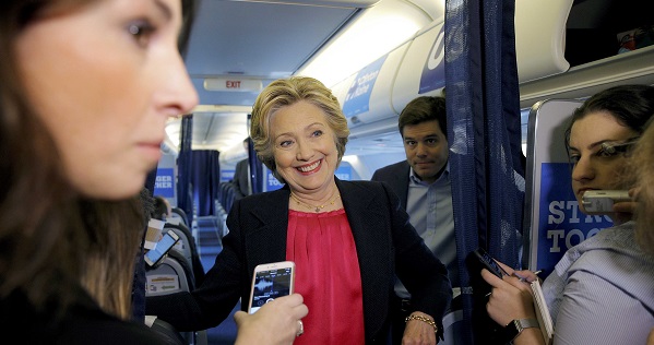 U.S. Democratic presidential candidate Hillary Clinton talks to reporters on her campaign plane in White Plains, New York.
