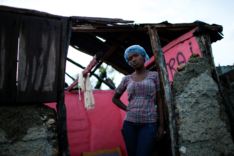 Carine Louis-Jean, 22, poses for a photograph in her destroyed house after Hurricane Matthew hit Jeremie, Haiti, October 17, 2016. 