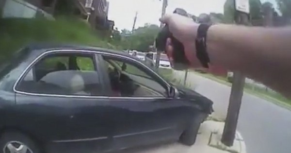 A frame grab from a body cam video shows Tensing with his gun drawn as he approaches the vehicle containing DuBose's body after shooting him.
