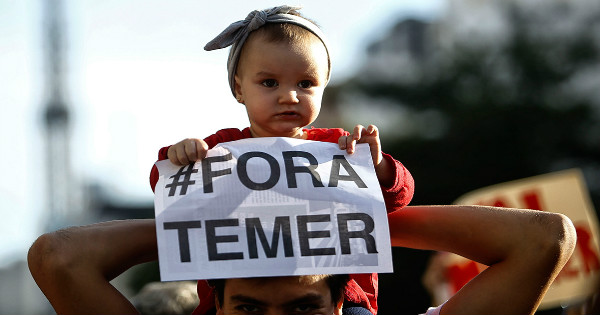 A child holds a sign reading 'Temer out' in a protest against Brazil's acting president Michel Temer in Sao Paulo
