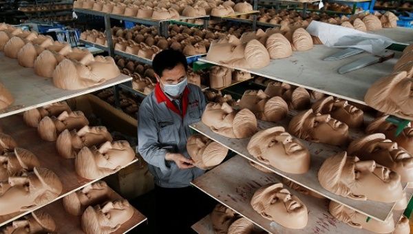A worker checks a mask of Donald Trump at Jinhua Partytime Latex Art and Crafts Factory in Jinhua, Zhejiang Province, China, May 25, 2016.