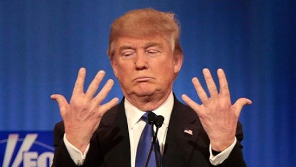 Donald Trump shows off the size of his hands at the Fox News debate in Detroit earlier this year.