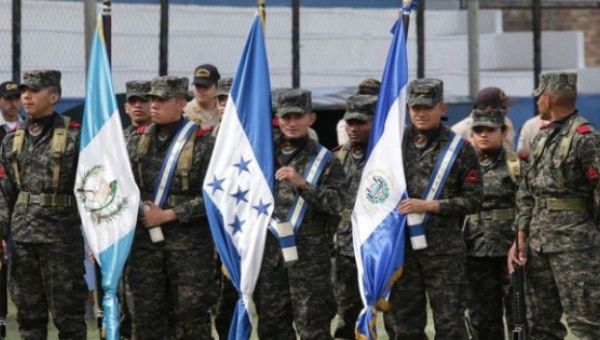 Soldiers from the Trinational Force hold the flags of Honduras, El Salvador and Guatemala during operations