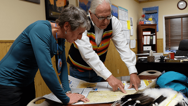 Blackfeet Nation Chairman Harry Barnes and Interior Secretary Sally Jewell review a map of the Blackfeet reservation.
