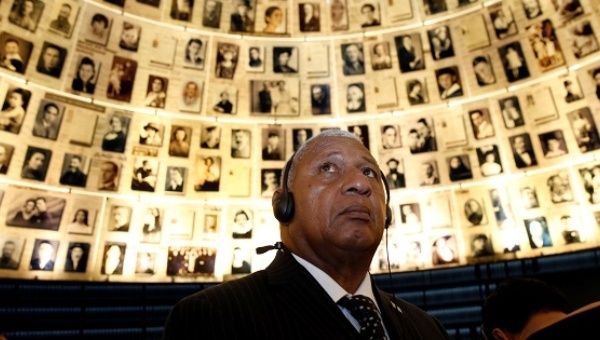 Fiji's Prime Minister Josaia Voreqe Bainimarama looks at pictures of Jews killed in the Holocaust during a visit to the Hall of Names at Yad Vashem's Holocaust History Museum in Jerusalem.
