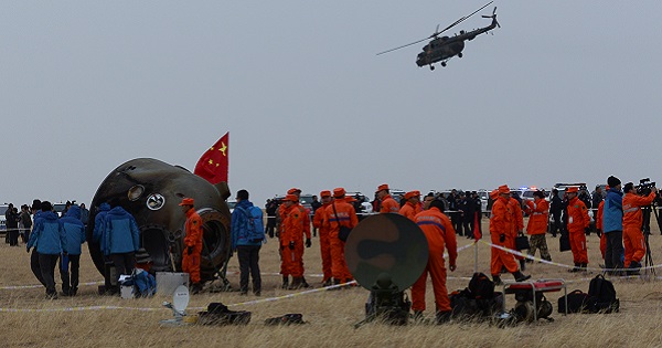 Researchers examine the re-entry capsule of China's Shenzhou-11 spacecraft after it landed on earth safely with two astronauts, Nov. 18, 2016.
