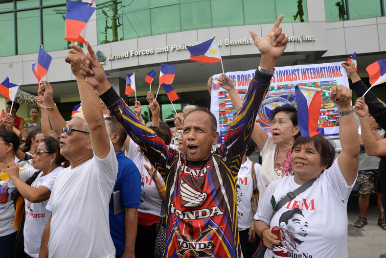 Supporters celebrate outside the Libingan ng Mga Bayani (Heroes' Cemetery) where burial rites for the former Philippine dictator Ferdinand Marcos took place, in Taguig city, Metro Manila, Philippines, Nov. 18, 2016.