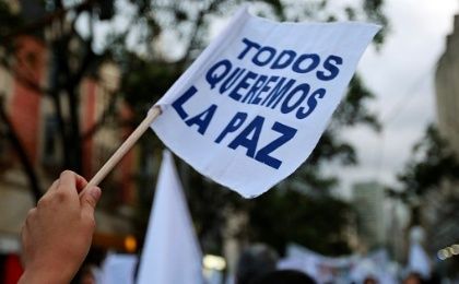 A supporter of a new peace agreement with FARC holds a banner that reads 