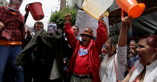 Demonstrators holding buckets protest over the ongoing drought in the center of La Paz, Bolivia, Nov. 18, 2016.