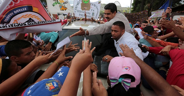 Venezuela President Nicolas Maduro greets supporters as he arrives for his weekly broadcast in La Victoria, Venezuela Nov. 20, 2016.