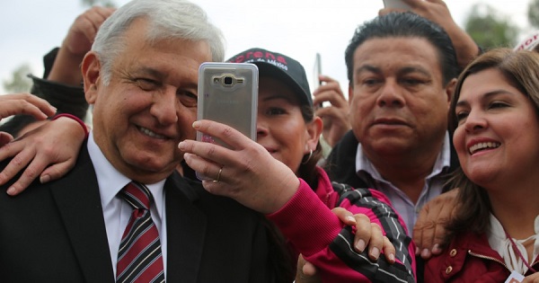 Andres Manuel Lopez Obrador takes a selfie with supporters during Morena's National Conference in Mexico City, Nov. 20, 2016.