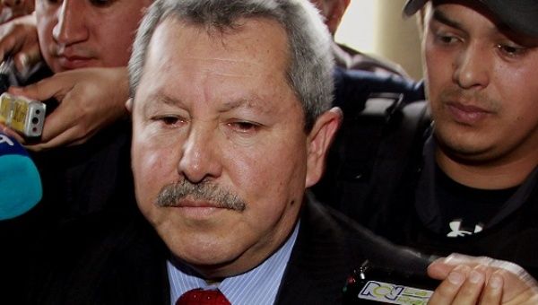 Authorities detain retired General Flavio Buitrago for suspected fraud and drug trafficking ties in Bogota, Colombia, Sept. 13, 2013.