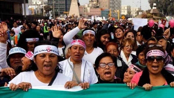 People in Peru take part in a rally to protest violence against women in Lima, Aug. 13, 2016. 