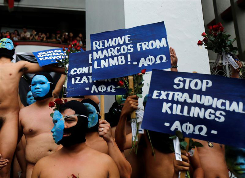 Masked members of the Alpha Phi Omega fraternity in the University of the Philippines, Diliman, ran naked through a packed crowd with only their faces covered to protest against the hero's burial of the late dictator Ferdinand Marcos.