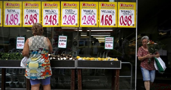 A woman looks on prices at a food market in Rio de Janeiro, Brazil, Jan. 21, 2016