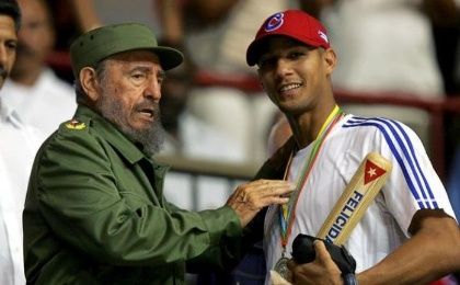 Then-Cuban President Fidel Castro (L) hands out a baseball bat to Cuban player Yulieski Gourriel in Havana in this March 21, 2006 file photo.