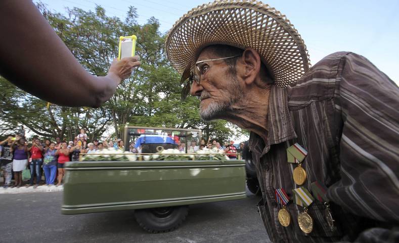 Guillermo Enrique Cadiz, 82, who fought with Fidel Castro in the Sierra Maestra, watches as Castro's ashes pass him during a three-day journey to the eastern city of Santiago, in Jovellanos, Cuba, November 30, 2016. 