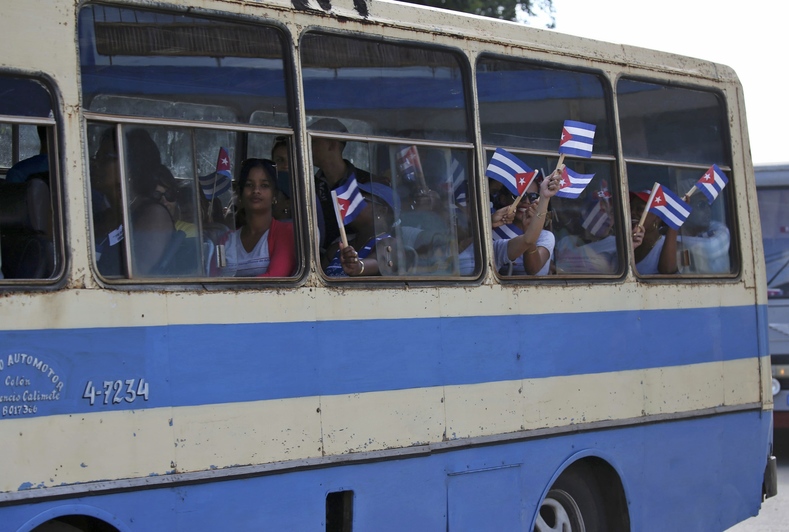 People are transported to greet the caravan carrying the ashes of Fidel Castro in Colon, Cuba, Nov. 30, 2016.