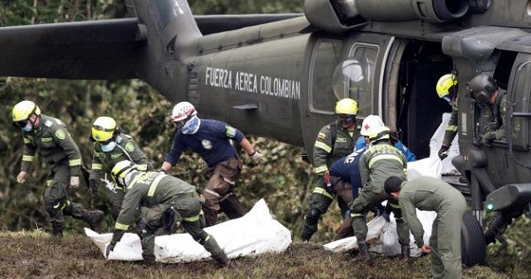 A Colombian air force helicopter retrieves the bodies of victims from the wreckage of a plane that crashed near Medellin, Colombia, Nov. 29, 2016.